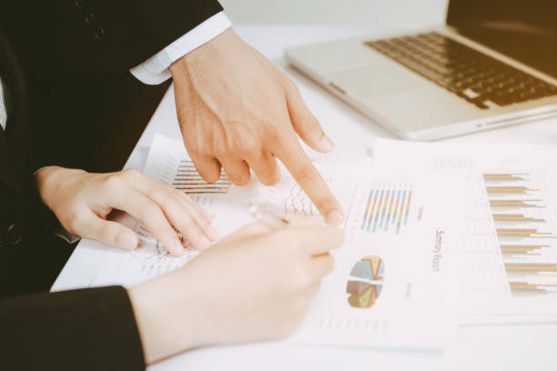 istock two business discussing the scheme and pointing handles on the chart 854744130