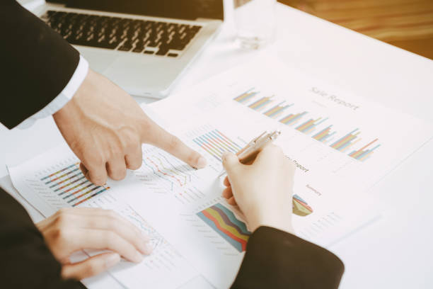 istock two business discussing the scheme and pointing handles on the chart 854744292