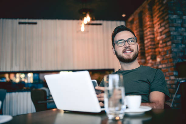 istock Young Hipster Freelancer Drinking Coffee and Working In Cafe Restaurant 854748062