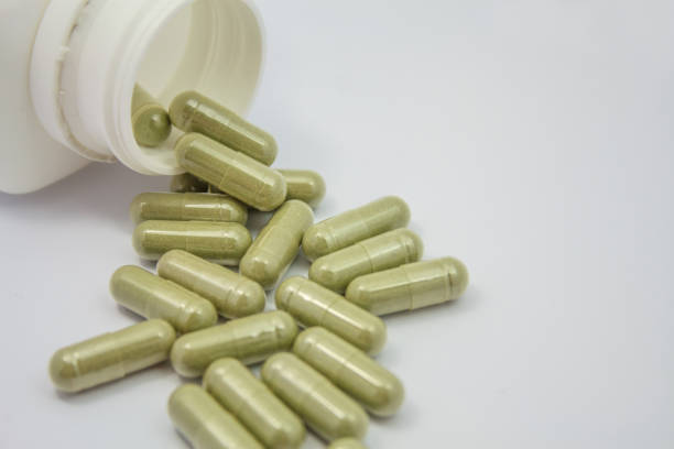 istock herbal capsules spilling out of a bottle 854758280