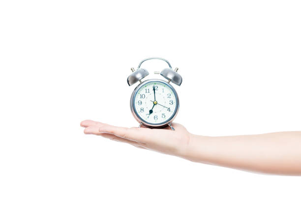 istock man's hand on a white background isolated with an alarm clock in retro style 854759558
