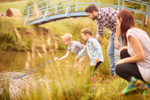 istock pond dipping family 854762122