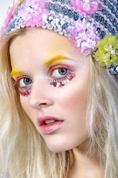 istock Young girl with colorfull makeup in sparkling hat 854765300