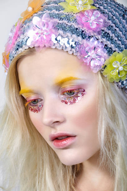 istock Young girl with colorfull makeup in sparkling hat 854765414
