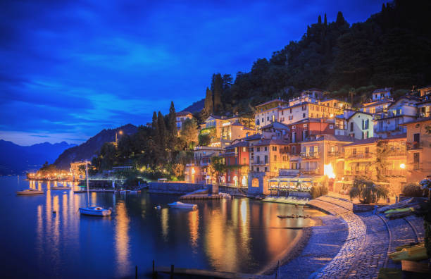 Varenna on the shore of Lake Como, Italy, showing houses, bars and restaurants in the evening. stock photo