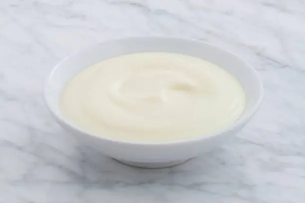 gorgeous styled greek yogurt on carrara marble countertop