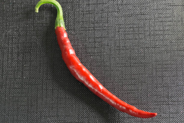 istock Red peppers isolated on a black background. 854775590