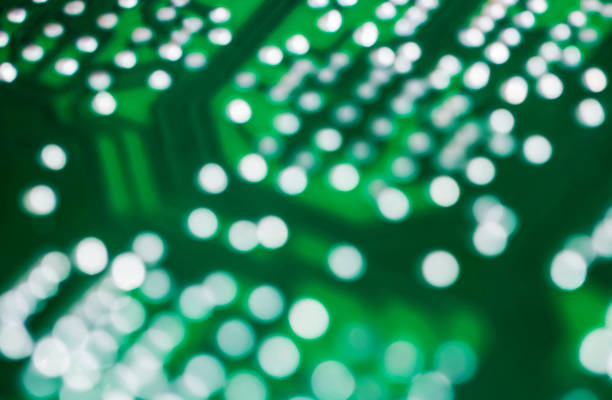istock Abstract blur bokeh green circuit board background 854779756