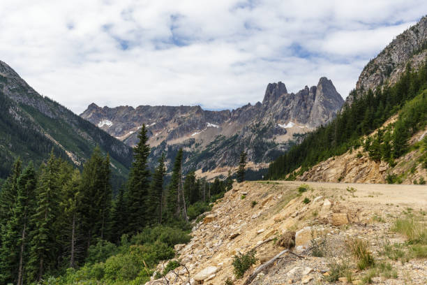 Liberty Bell Mountain A mountain highway leading up to Washington Pass and Liberty Bell mountain revealing a rugged landscape environment. liberty bell mountain stock pictures, royalty-free photos & images