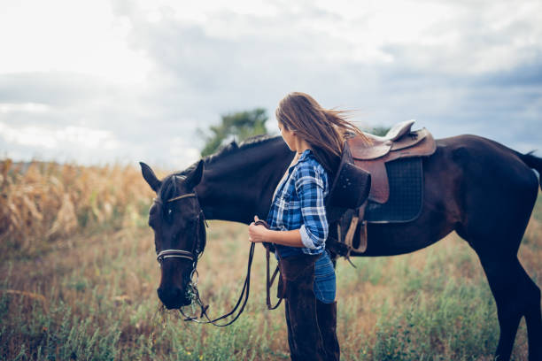 istock Woman looking at her horse 854803832
