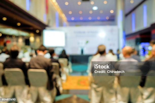 Blurred View From Behind The Audience On Seminar Stock Photo - Download Image Now - Large, Conference - Event, Meeting