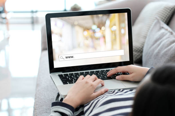 istock Hand tying laptop computer with www. on search bar over blur store background on screen, on line shopping , business and technology, E-commerce, digital marketing concept 854815470