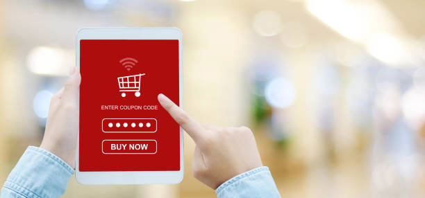 istock Hand holding tablet with discount coupon code on screen over blur store background with copy space, banner, on line shopping ,business and technology, digital marketing background 854818408