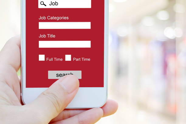 istock Hand using smart phone searching job online on screen device, business and technology concept 854818412