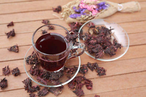 istock Roselle juice with dried roselle on wooden plank. 854859470