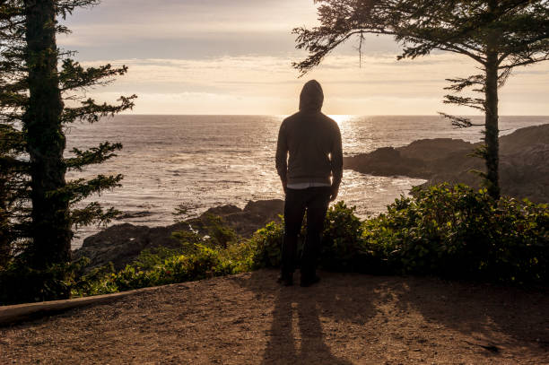 istock Standing man overlooking sea on Vancouver Island at sunset 854863058