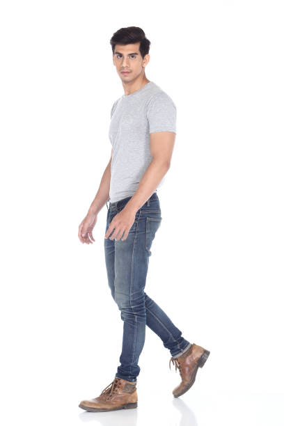Asian black hair, handsome muscle good looking man Tan Skin Asian black hair, handsome muscle good looking man in grey t shirt jean pant brown shoes, stand pose in studio lighting white background, male model walk pose asian suit man cross hand stock pictures, royalty-free photos & images