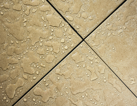 Water drops on bathroom tiles close up.