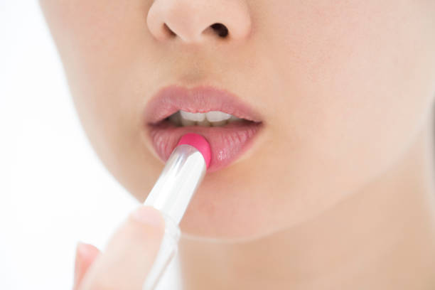 istock A woman's mouth that paints lipstick. 854884782