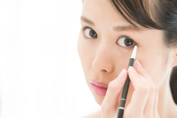 istock A woman who makes an eye makeup. 854884934