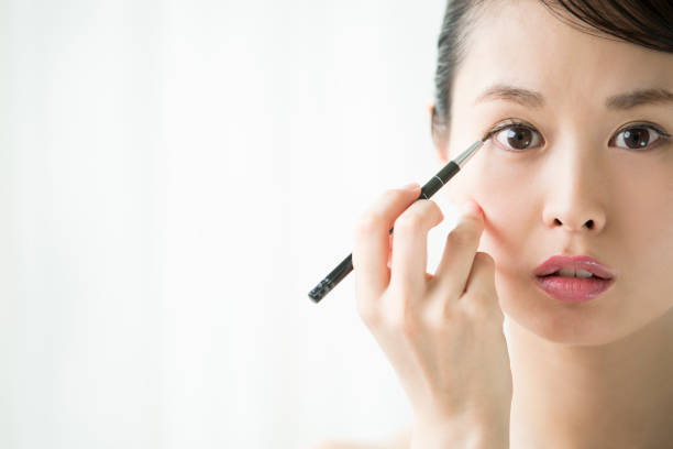 istock A woman who makes an eye makeup. 854885860