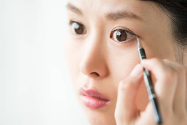 istock A woman who makes an eye makeup. 854885880