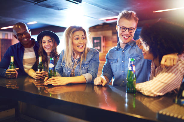 istock Cheerful people with beer in the bar 854892842