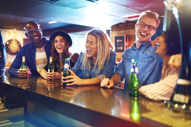 istock Laughing group of people drinking in tavern 854893054