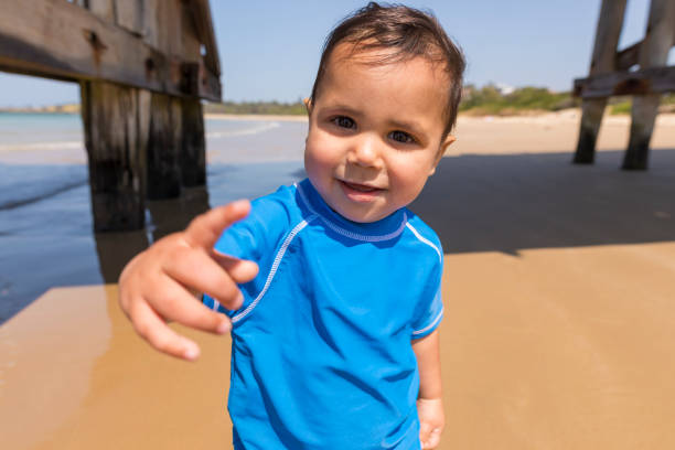 istock Happy Aboriginal Australian Boy Playing at the Beach 854893764