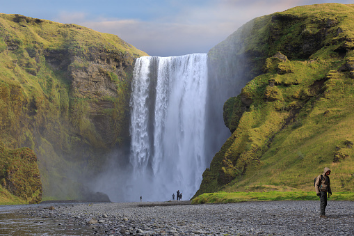 Beautiful of Skogafoss waterfall with some tourist walking away, Iceland