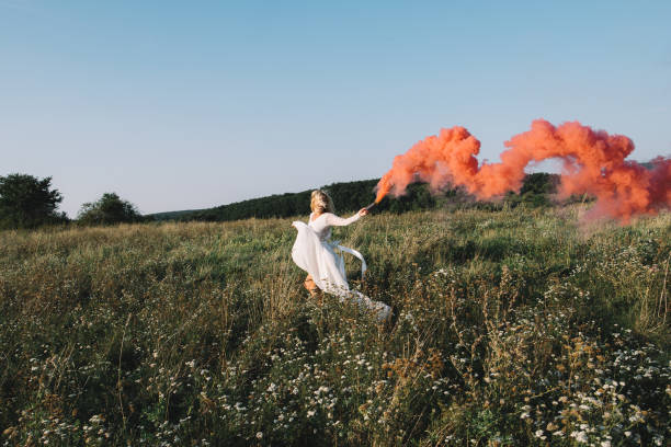 istock Beautiful bride running with red smoke 854903128
