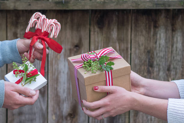 istock Romantic couple exchanges holiday Christmas gifts in a rustic setting 854903586