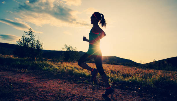 istock trail runner woman running on forest trail 854915920