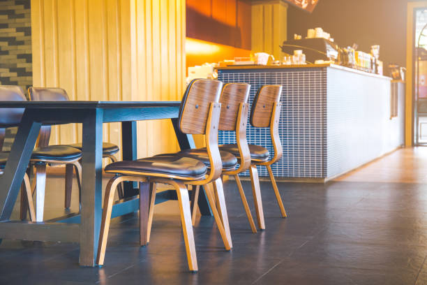 istock Table and wooden chairs in a modern coffee shop. 854923348