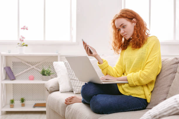 istock Young girl with laptop indoors 854924480
