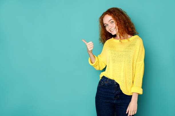 istock Young beautiful woman with thumb up portrait 854924694