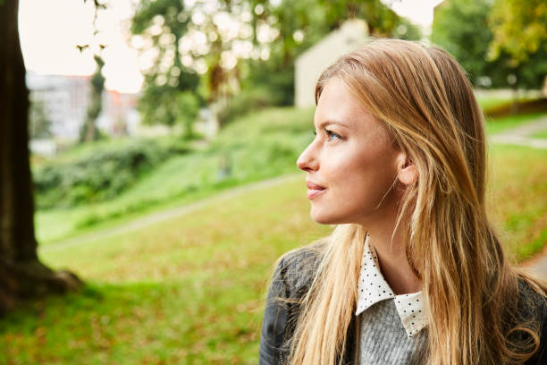 istock Beautiful woman in park 854929486