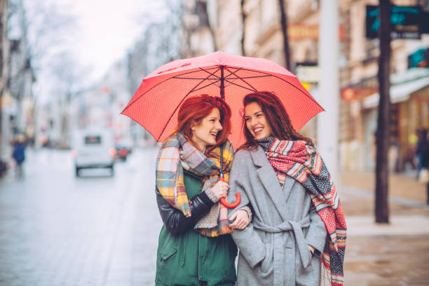 Don't let the rain stop us in shopping Friens enjoy in shopping, they walking through city and preparing gifts for Christmas city street consumerism window display vienna stock pictures, royalty-free photos & images