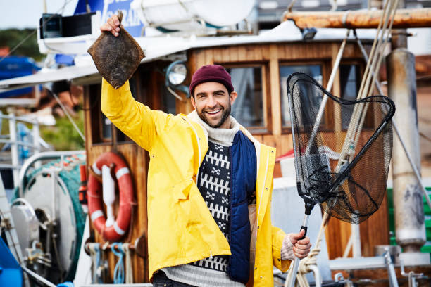 istock Proud fisherman with plaice 854941868