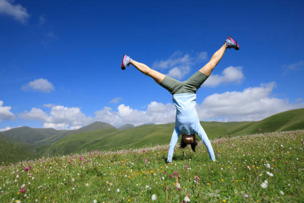 istock handstand woman have fun in a mountain peak meadow 854942064