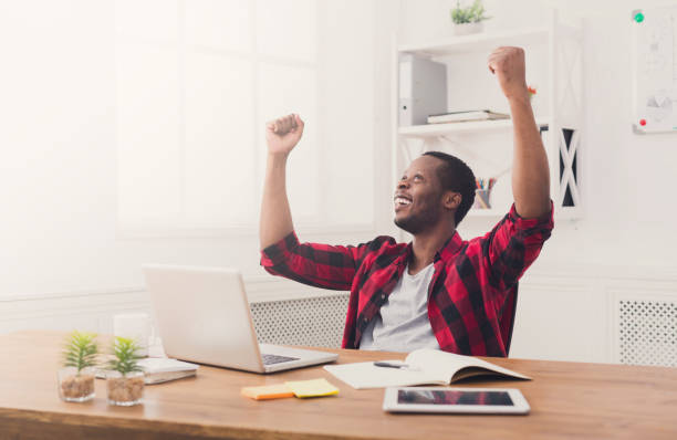 istock Happy businessman win. Winner, black man in office 854949478