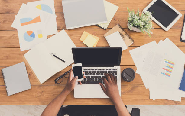istock African-american businessman at work, table top view 854949878