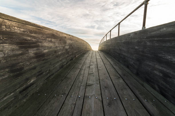 istock wood bridge with clouds and sky above 854950780
