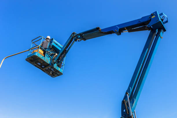 istock Electrical technician repairing street light by boom lift 854960322