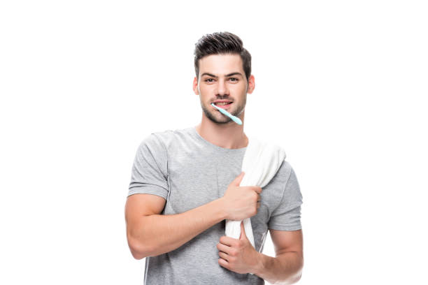 istock man with toothbrush and towel 854961662