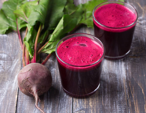 istock Fresh beet juice in glasses on a wooden background 854961818
