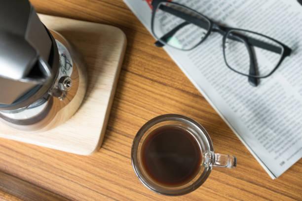 istock Hot Coffee in Espresso Cup with Magazine on the Table 854964330