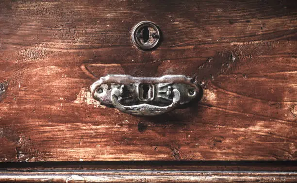 Old shabby case with door handles, are present dark and light tone. Processing of a photo in vintage style