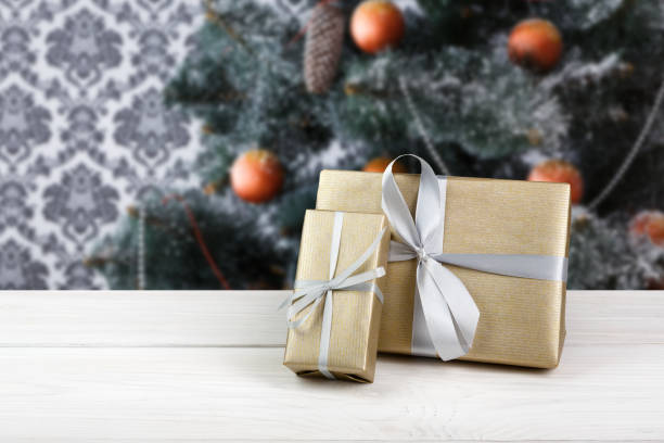 istock Christmas gifts on decorated tree background, holiday concept 854965420