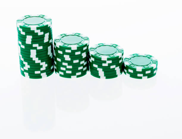 istock Stacks of green poker chips in a row 854965718